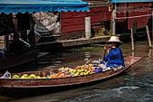 Thailand, Locals sell fruits, food and products at Damnoen Saduak floating market near Bangkok 